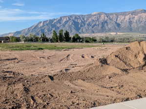 Expansive land parcel featuring level terrain, clear skies, and a distant mountain range
