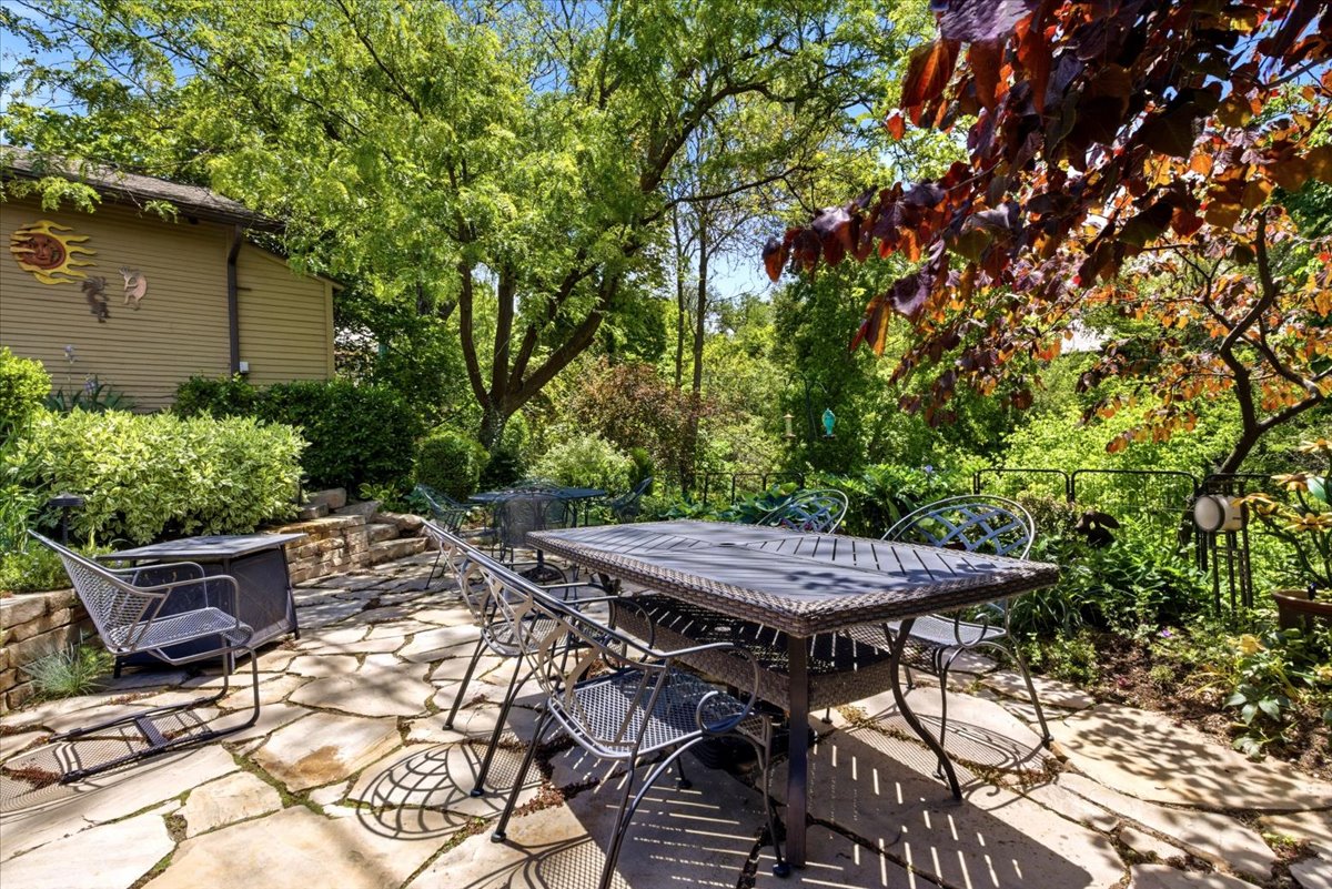 Stone patio with flagstone paving and a terraced stone retaining wall