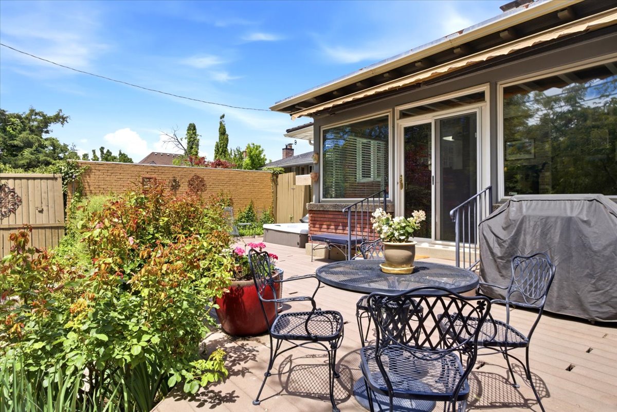 Outdoor deck space featuring a sliding glass door entry and large windows