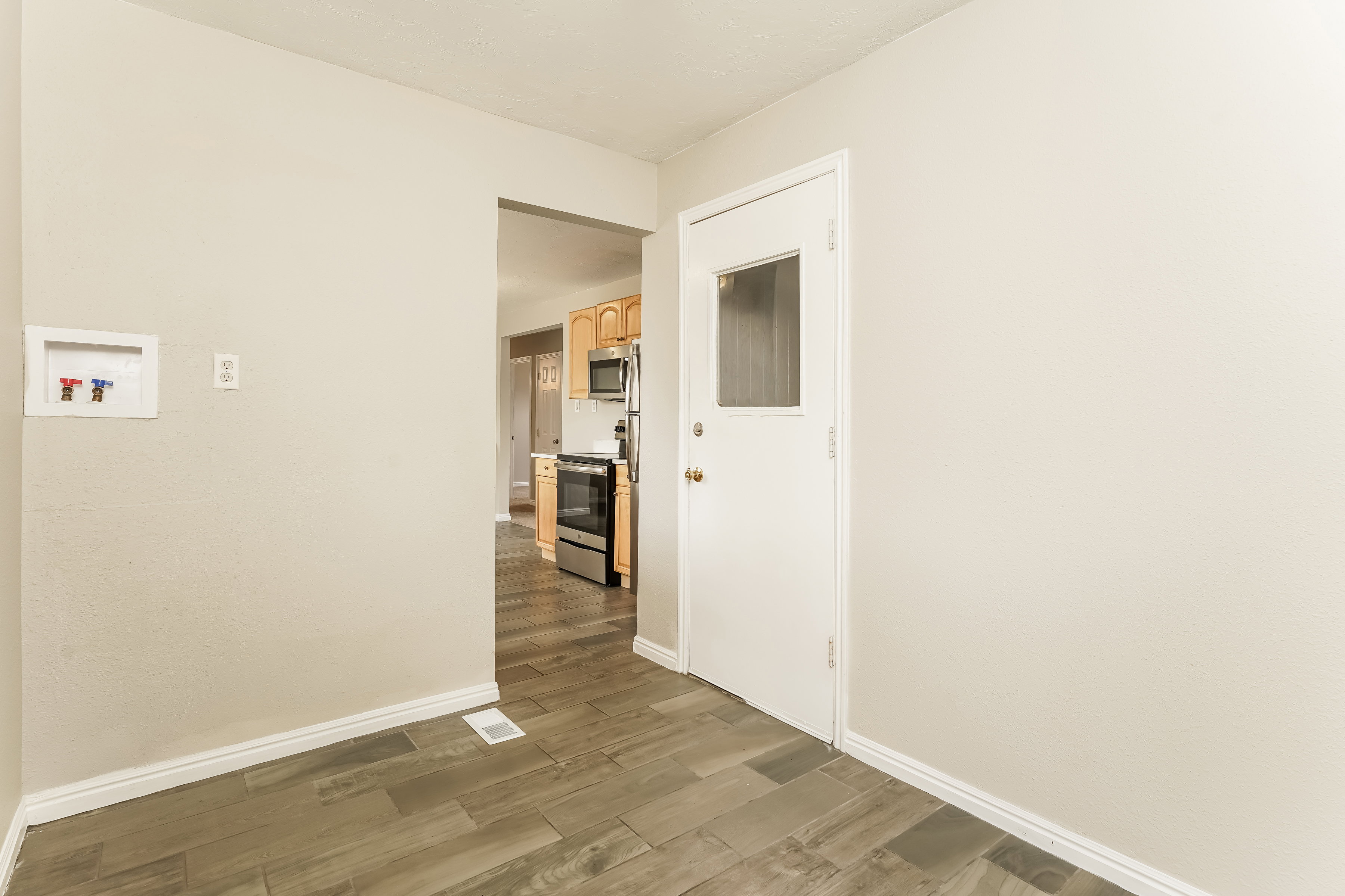Neutral-toned walls and wood-finish flooring define this interior space