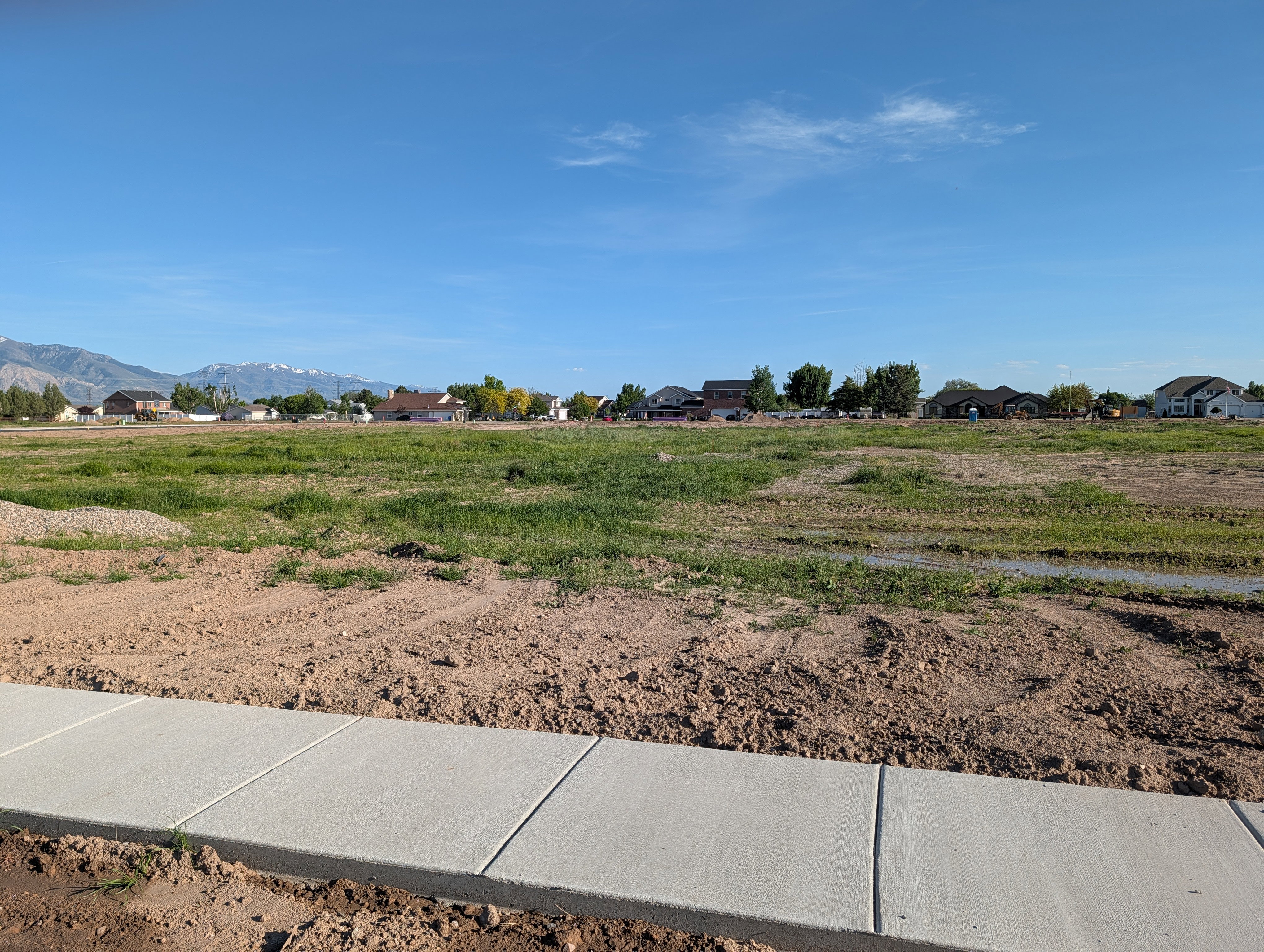 Level lot with a newly poured sidewalk