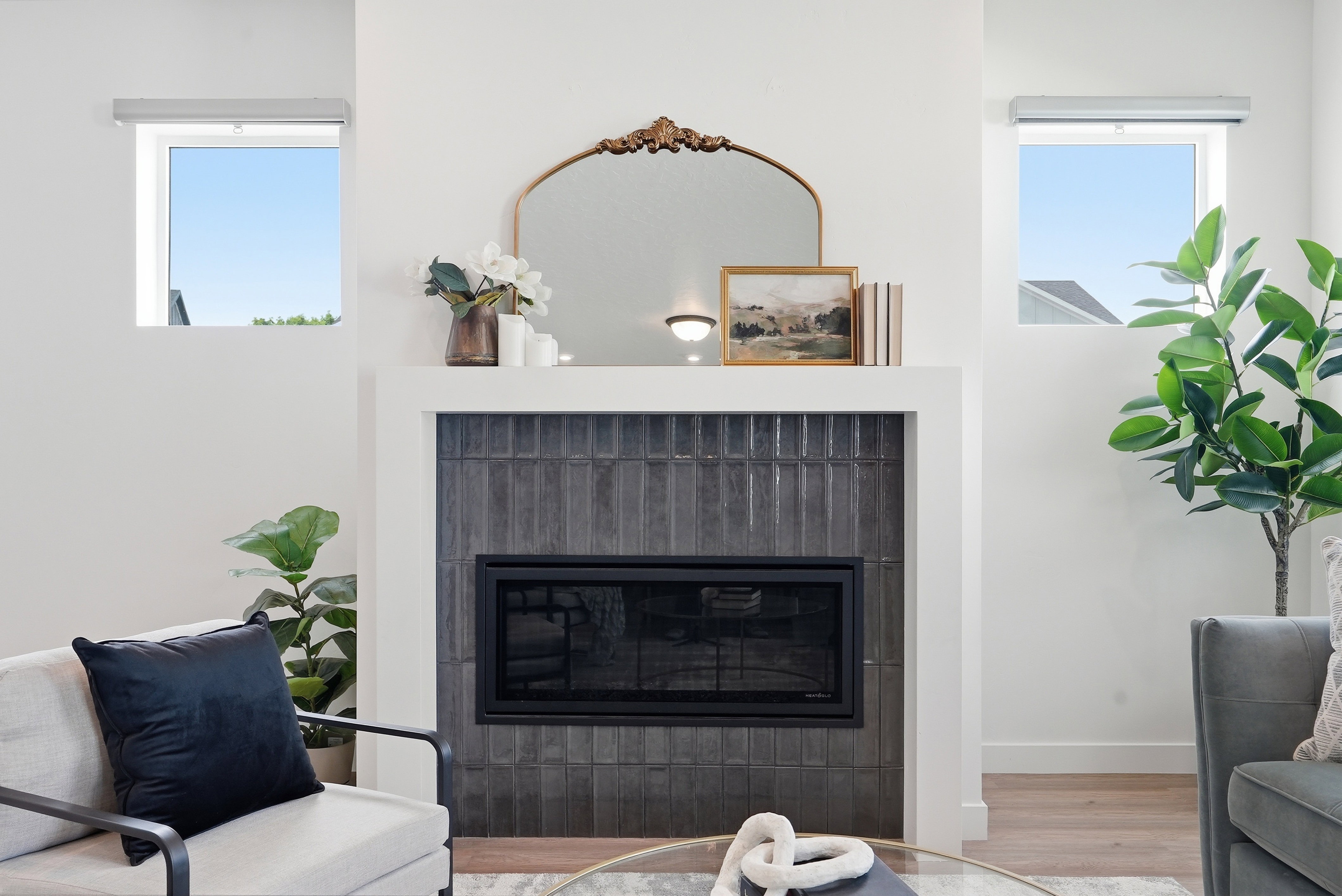 Modern fireplace featuring dark vertical tile surround and white mantel