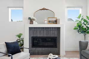 Modern fireplace featuring dark vertical tile surround and white mantel