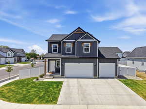 Contemporary two-story residence featuring dark gray siding and white trim accents