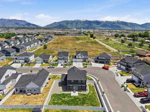 Contemporary residential development featuring a cul-de-sac design, uniform architectural styles, and mountain range scenery