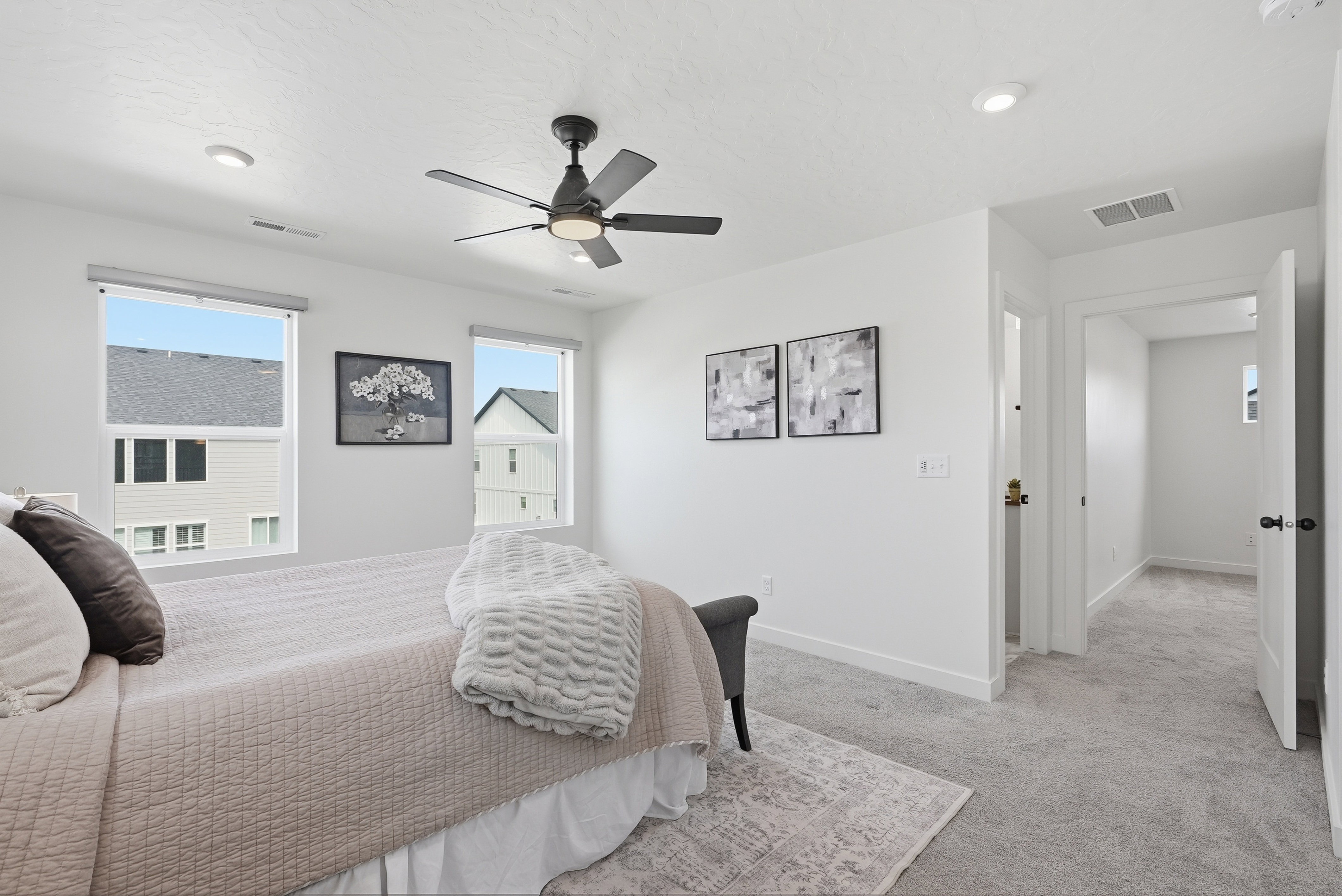 Interior space featuring a contemporary ceiling fan with integrated lighting, recessed lighting, and two windows allowing natural light