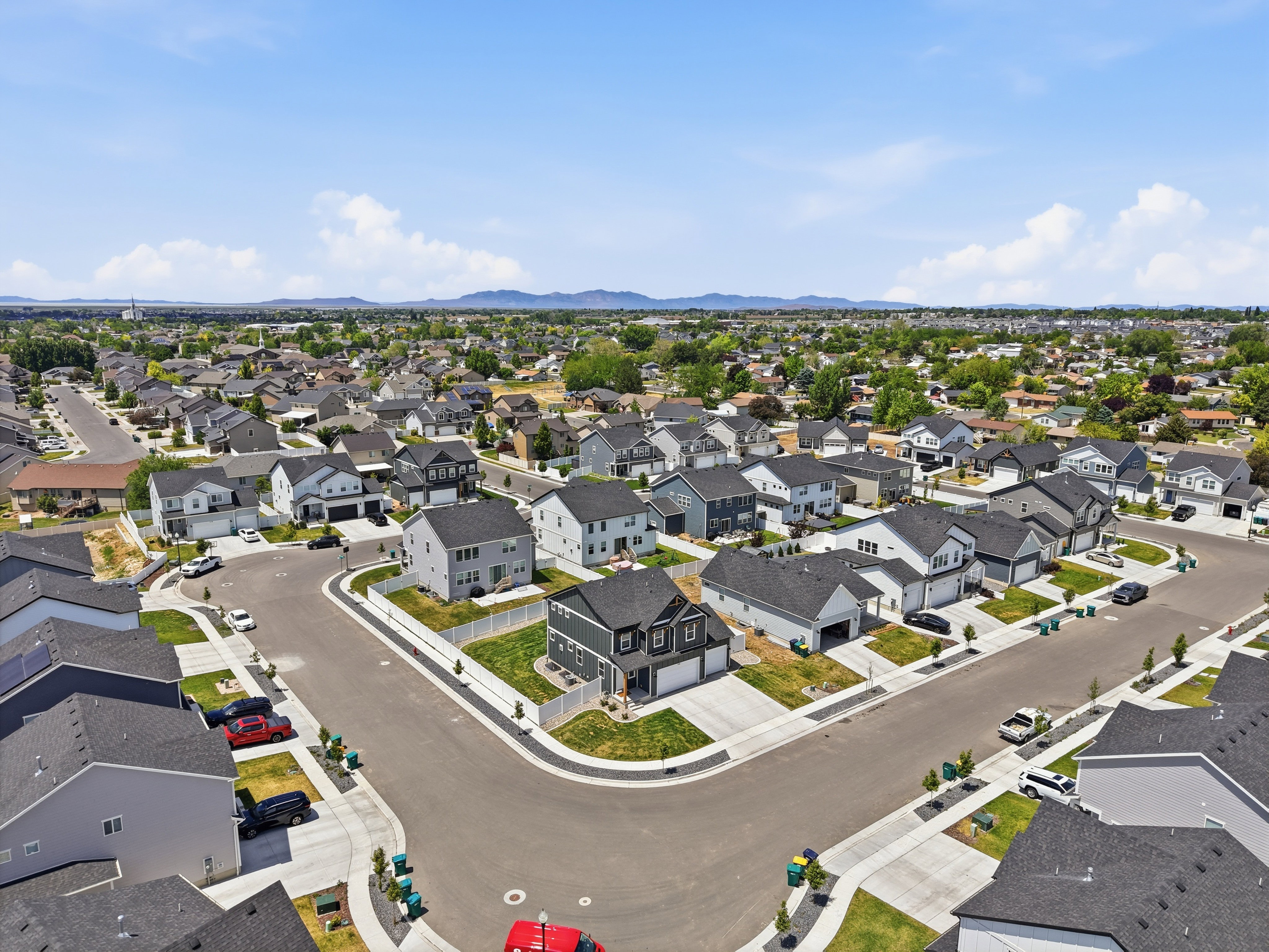 Expansive aerial showcasing a contemporary residential development with numerous single-family homes