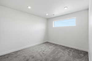 Neutral wall tones with a horizontal window and recessed lighting