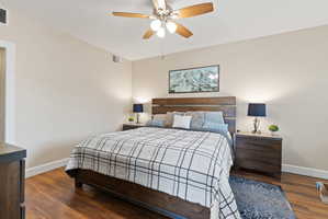 Spacious room featuring wood-finish flooring, a ceiling fan with integrated lighting, and neutral wall tones