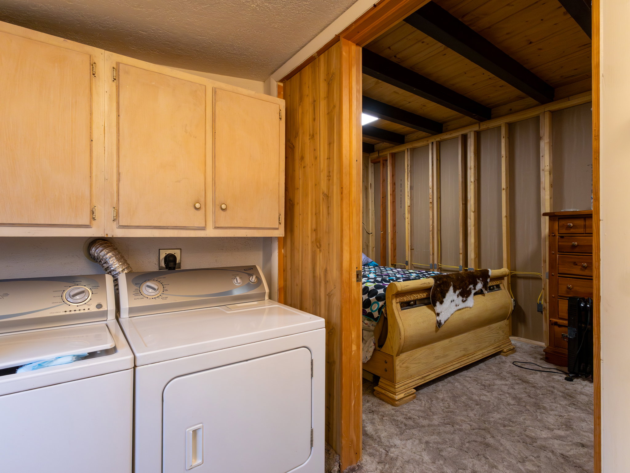 Dedicated laundry area with upper cabinetry and side-by-side appliances