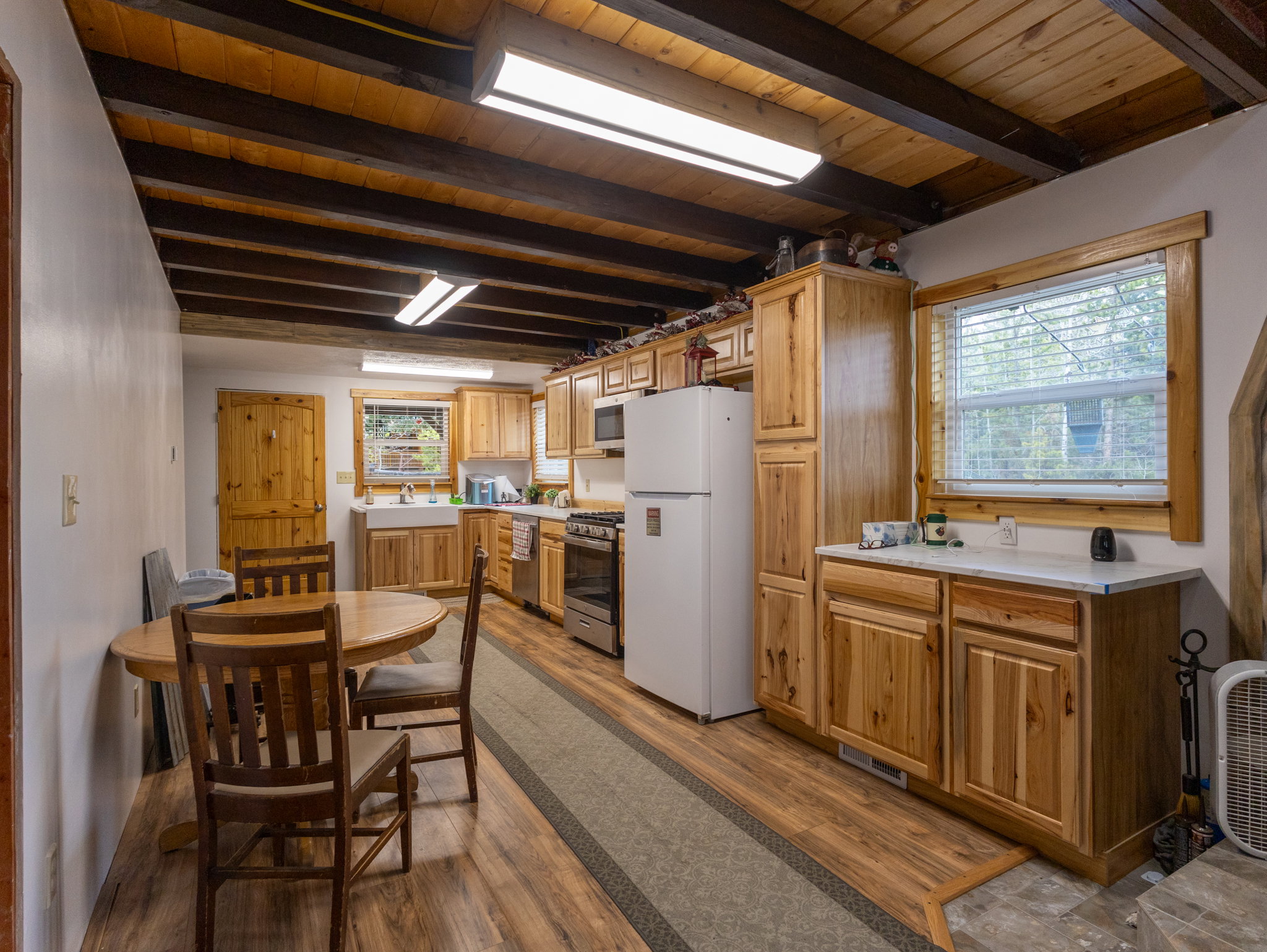 Kitchen featuring natural wood cabinetry and exposed wood ceiling beams