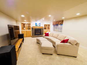 Large Family Room Downstairs with a Fireplace & Custom Built-in Cabinets with Shelving