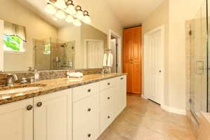 Updated White Bathroom Vanity with Double Sinks & Granite Countertops