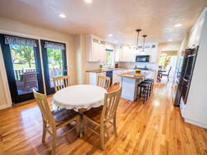 Open Kitchen & Dining Area with French Doors to Deck & Backyard