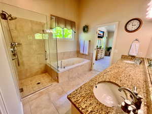 Primary Bathroom with Double Sinks, Granite Countertops, and a Separate Garden Tub & Shower