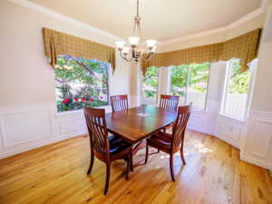 Cheerful Formal Dining Area with Lots of Windows & Hardwood Flooring