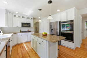 Updated Kitchen Featuring Stacked White Cabinets, Island Bar, Pantry, Double Ovens, & Refrigerator Included
