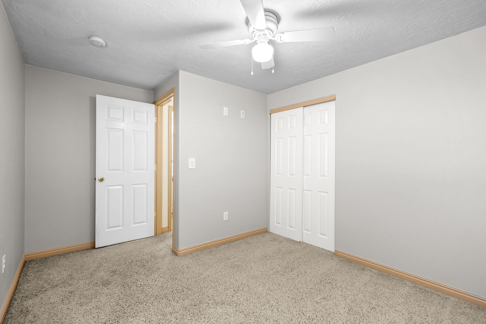 Neutral gray walls with light wood-finish baseboards
