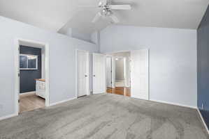 Spacious room with vaulted ceilings and a ceiling fan