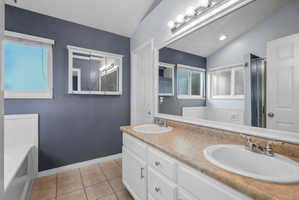 Double vanity with white cabinetry and a light-colored countertop