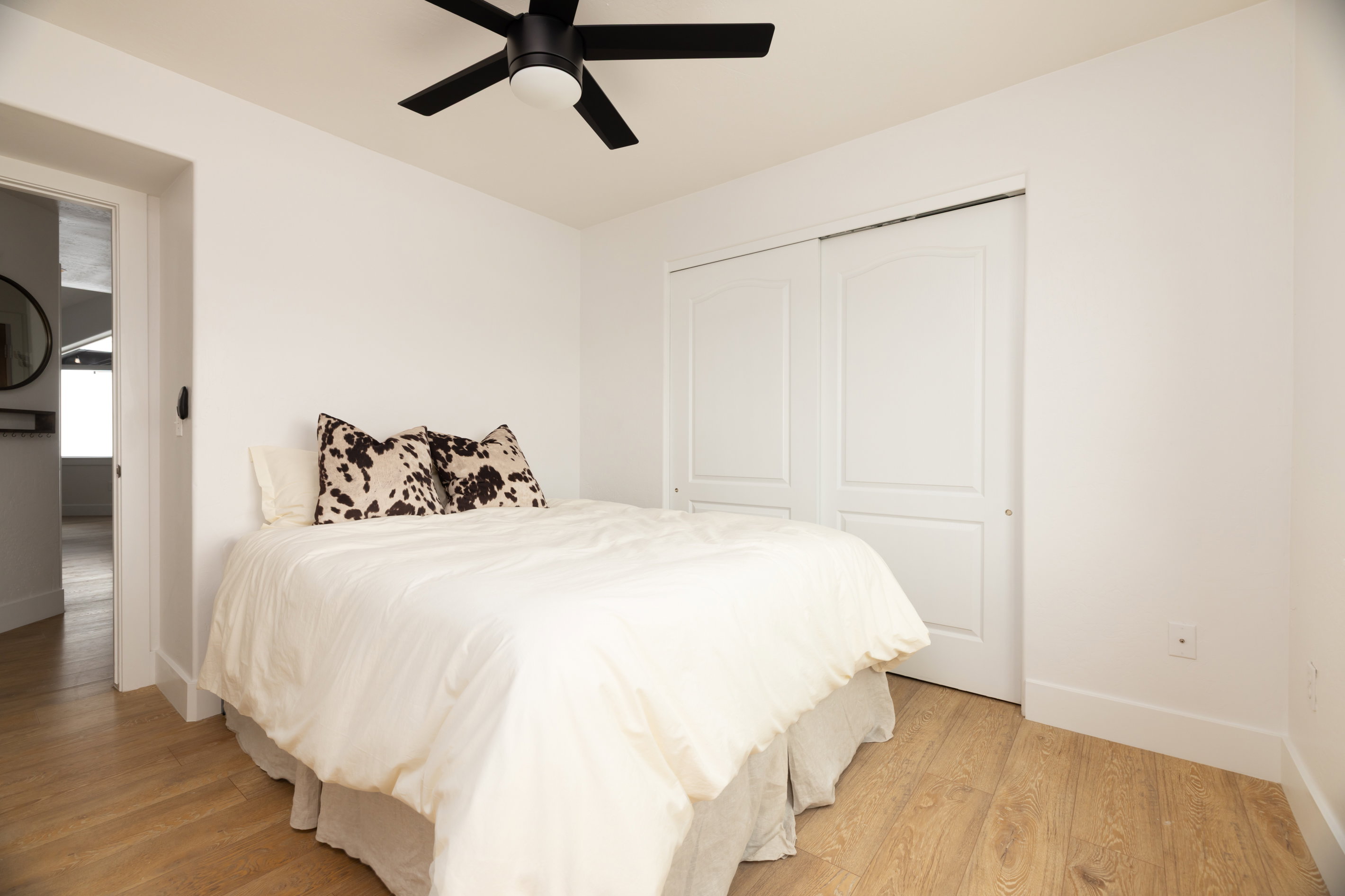 Light wood-finish flooring complements the bright white wall paint