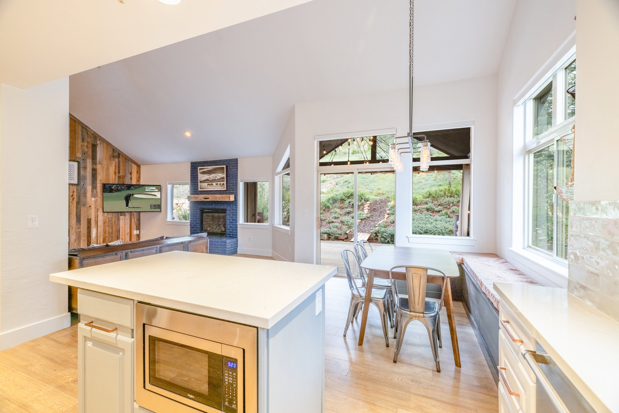 Open-concept living space featuring wood-finish flooring and high ceilings