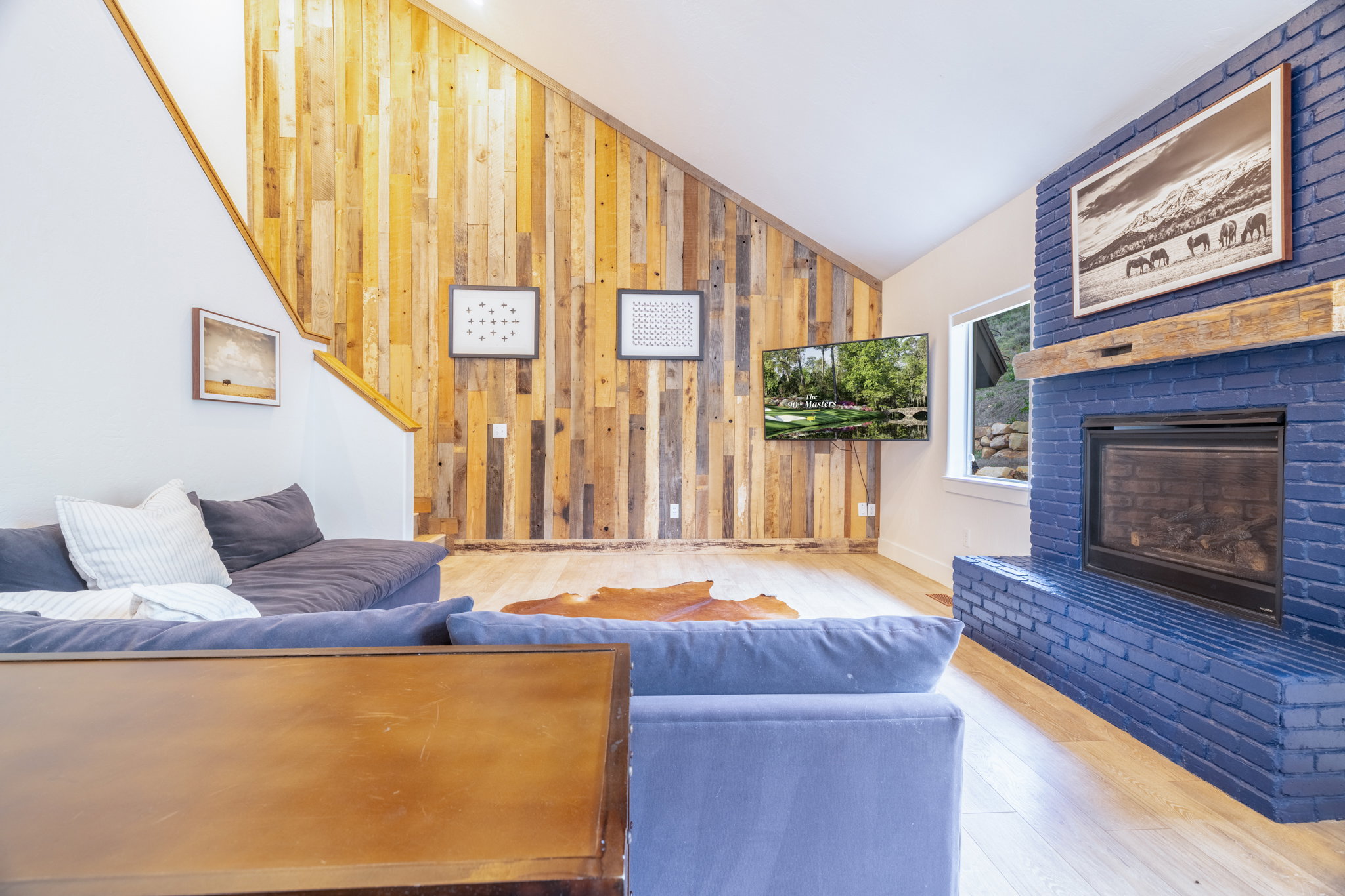Living area featuring a vaulted ceiling and light wood-finish flooring