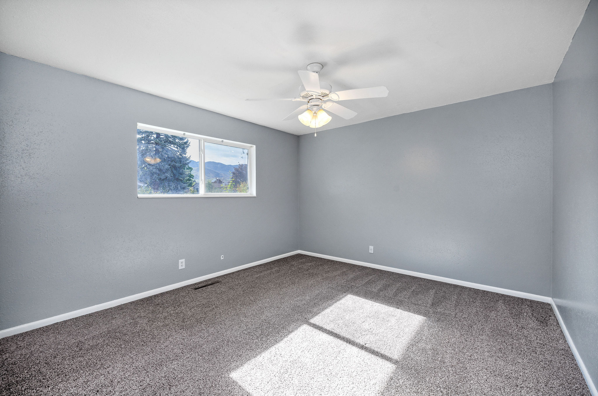 Bedroom featuring grey wall paint and grey carpeting