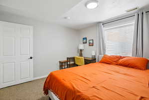 Bedroom featuring a window with blinds, light gray walls, and carpet flooring