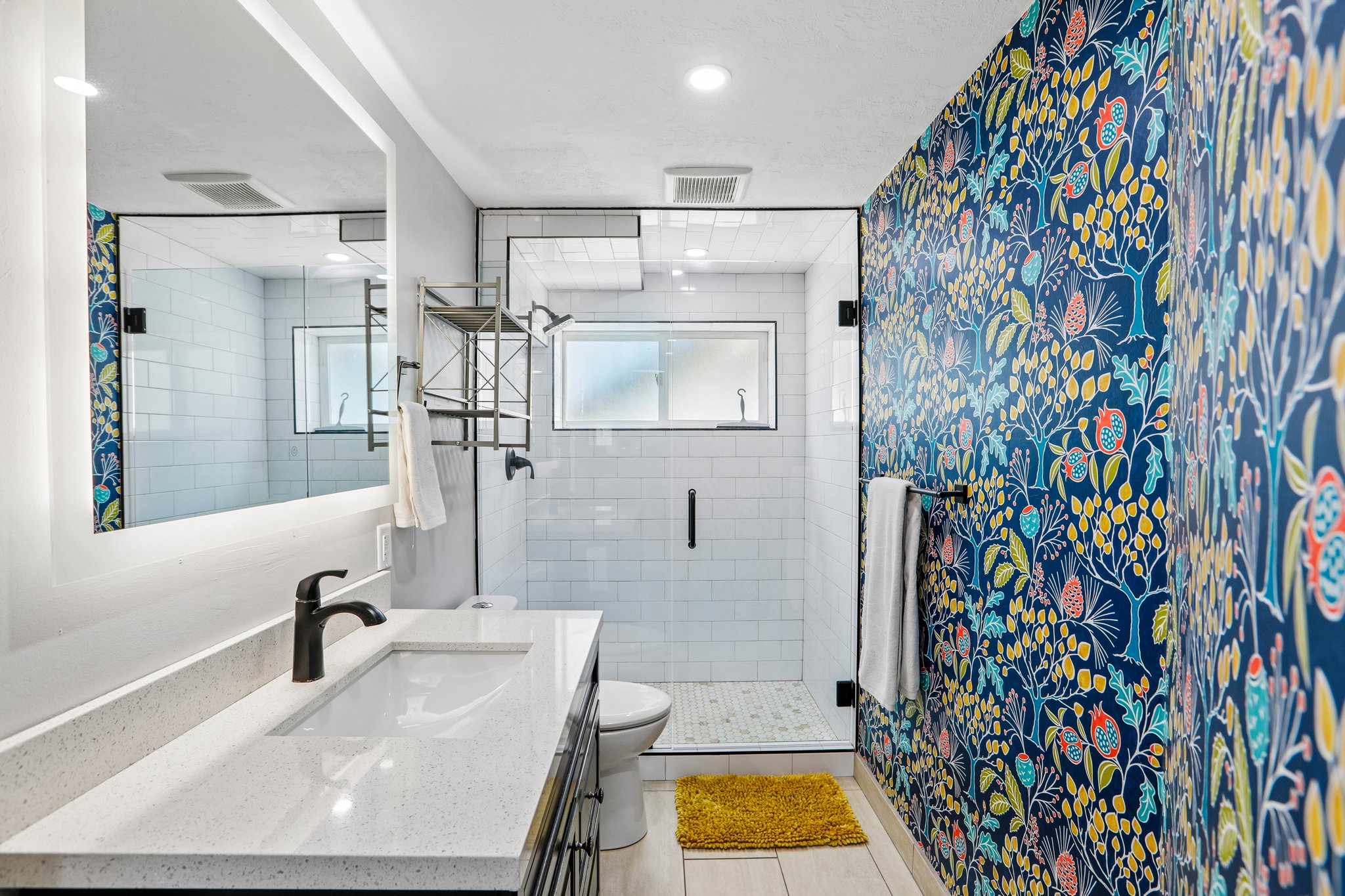 Contemporary bathroom featuring a spacious vanity with an integrated rectangular sink and quartz countertop