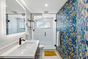 Contemporary bathroom featuring a spacious vanity with an integrated rectangular sink and quartz countertop