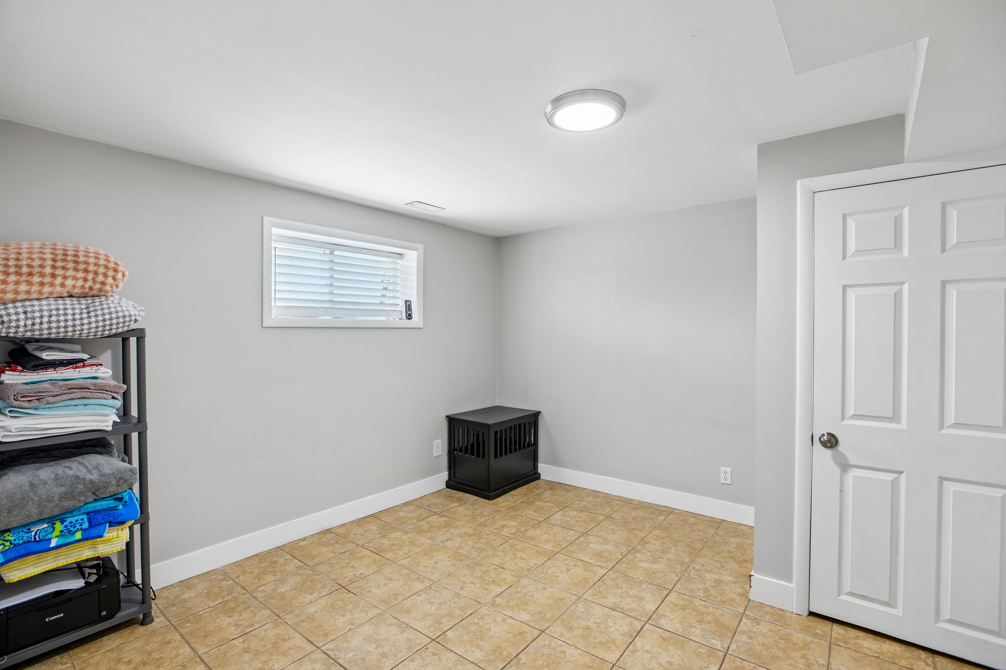 Neutral tone walls paired with light brown tiled flooring