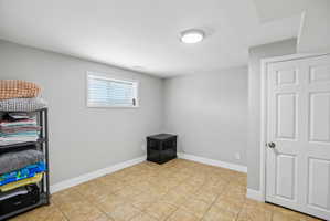 Neutral tone walls paired with light brown tiled flooring