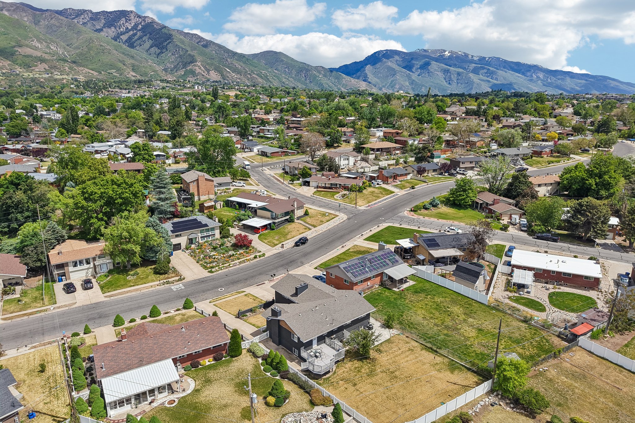 Aerial perspective showcasing the residential neighborhood with a backdrop of prominent mountains