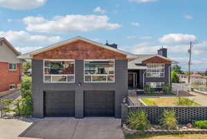 Contemporary-style exterior featuring gray brick and wood-finish siding accents