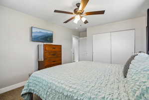 Spacious room featuring a ceiling fan with integrated lighting, wall-mounted television, and light-toned walls