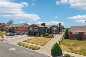 Dark-toned exterior featuring prominent architectural elements and multiple windows