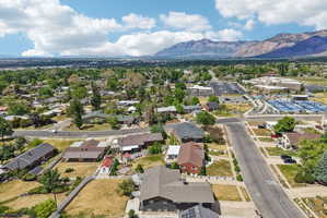Expansive aerial perspective showcasing a residential neighborhood with distant mountain ranges