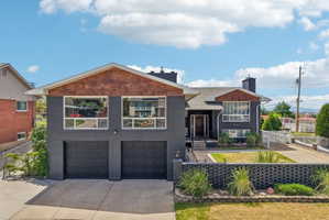 Modern exterior featuring dark gray brick and wood-finish siding accents