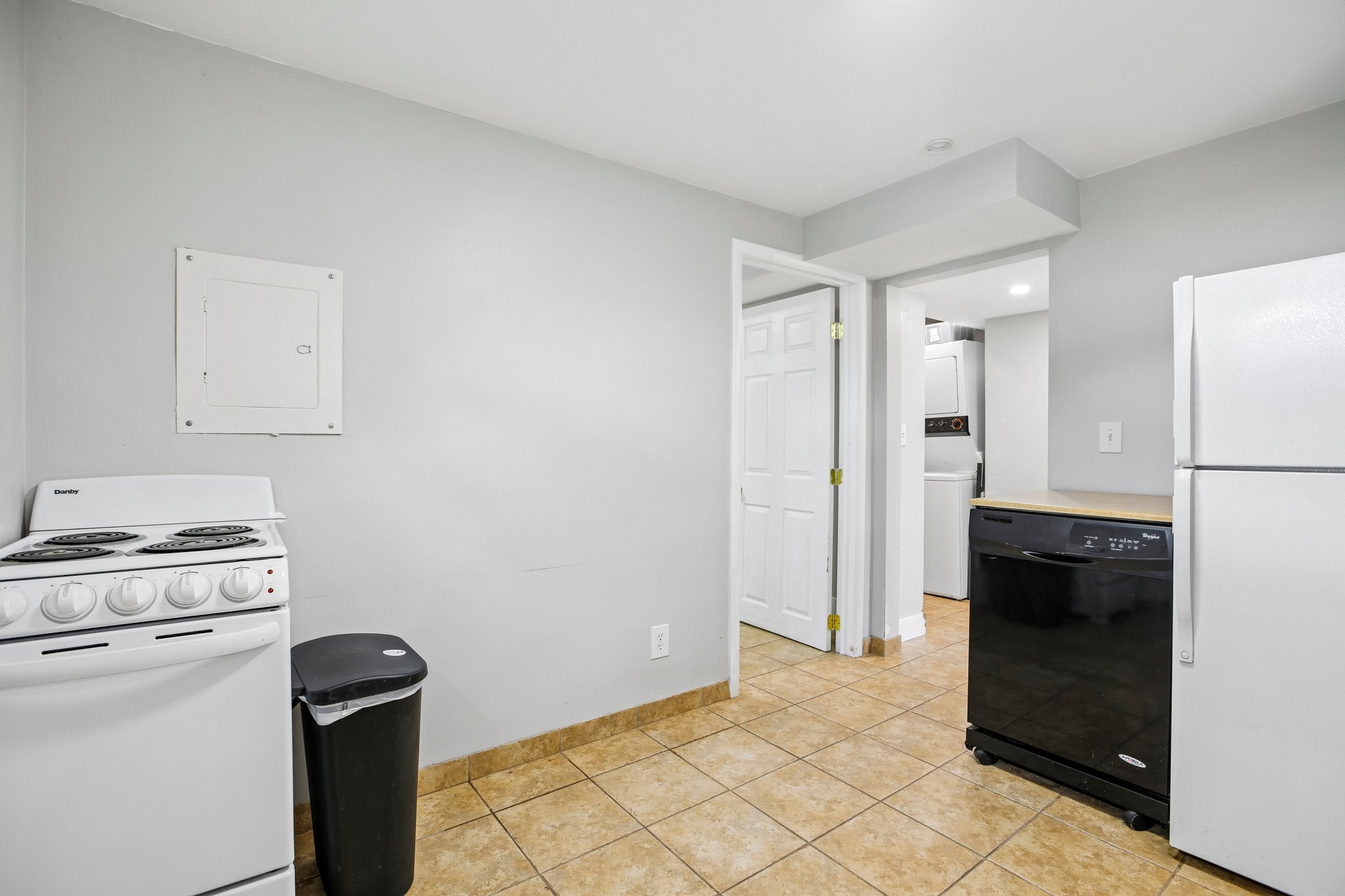 Kitchen area with tile flooring and light gray walls