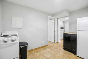Kitchen area with tile flooring and light gray walls