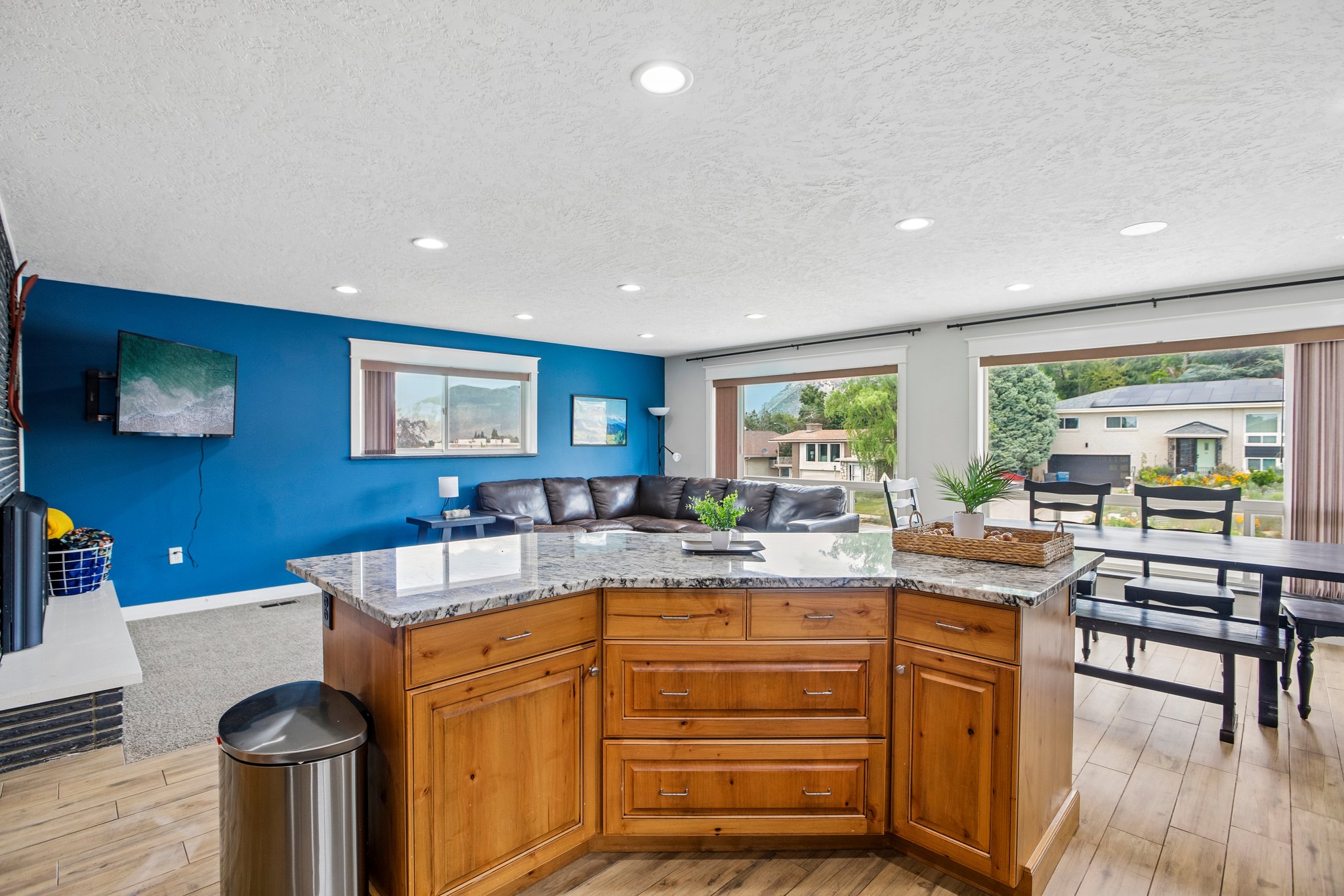 Kitchen island with wood-finish cabinetry and a speckled countertop