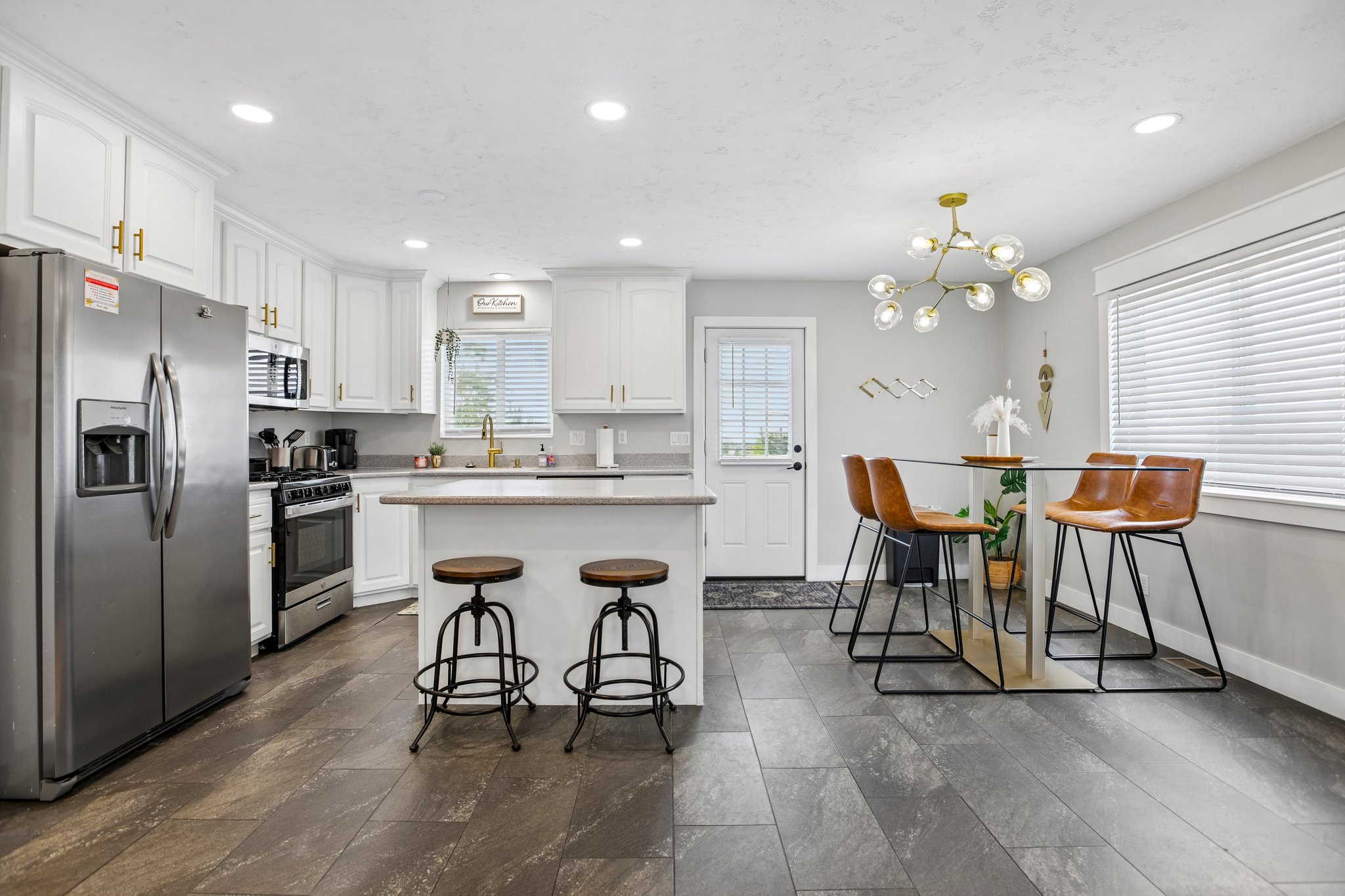Open-concept kitchen and dining area featuring wood-finish plank flooring