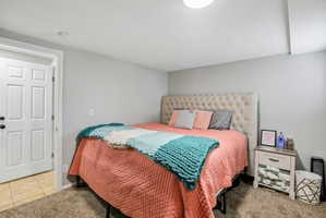 Bedroom featuring light gray walls and a neutral-toned carpet