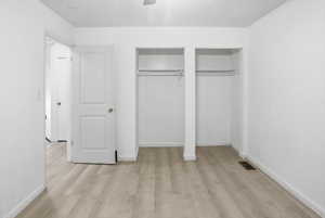Room featuring light wood-finish flooring, white walls, and white baseboards