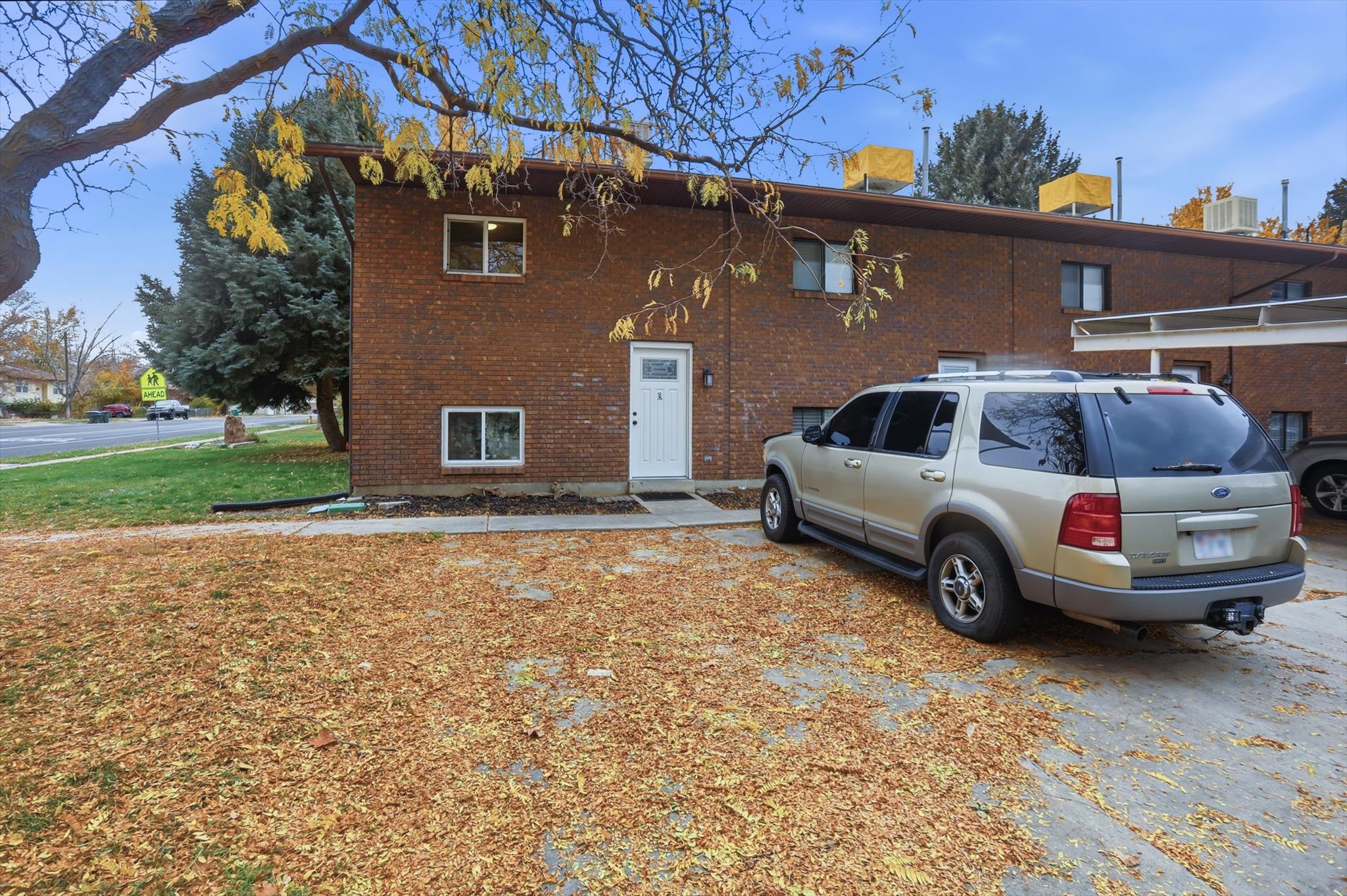 Brick exterior with white entry door and trim