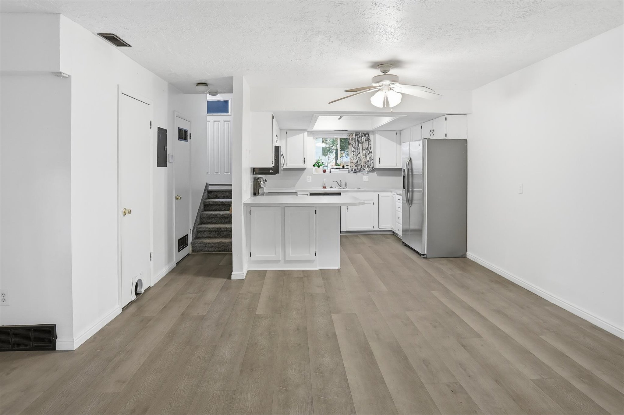 Bright interior featuring wood-finish flooring throughout