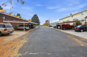 Expansive paved parking area offering covered carport spaces