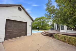 White brick exterior with a brown panel garage door