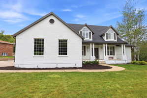 White brick exterior with dark gray roofing